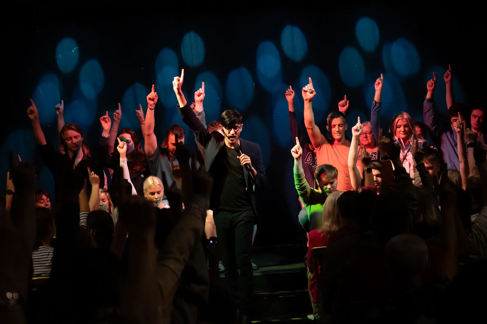 Daniel Sinclair performing on stage in front of a live audience